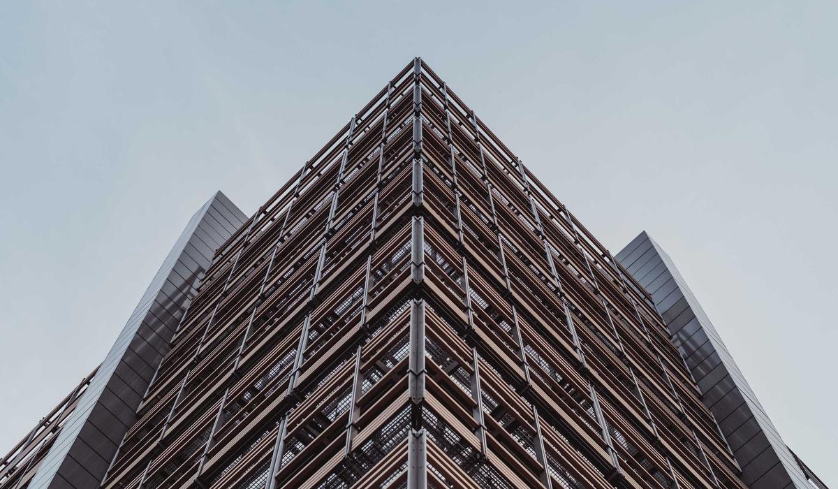 Looking up at the geometric facade of a modern building